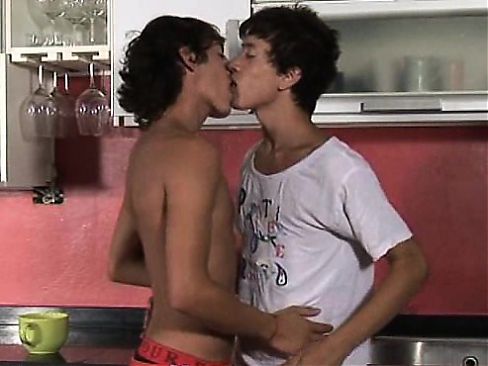 Passionate twinks kiss and go down in the kitchen